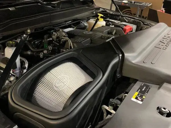 Car engine with visible air filter.