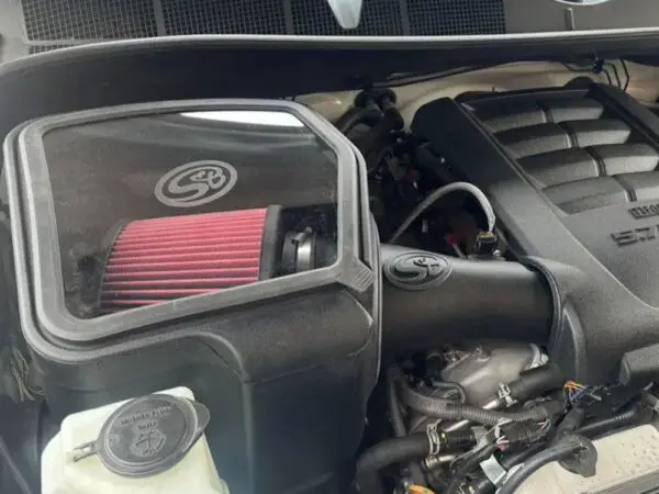 Car engine with performance air filter installed.