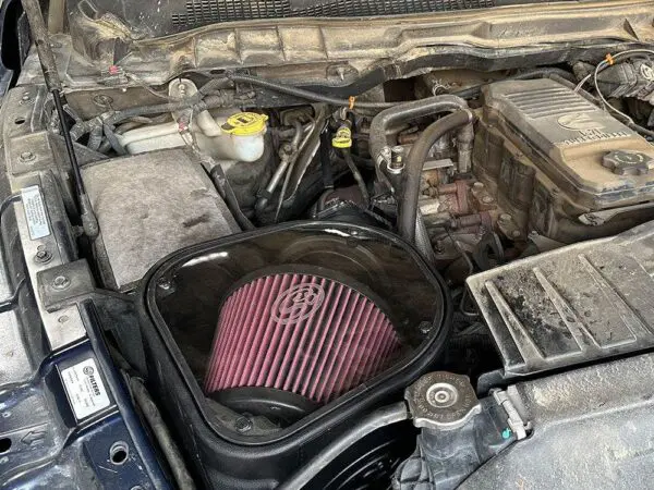 Car engine with exposed air filter.