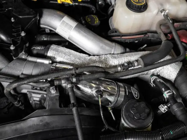 Car engine with various visible components.