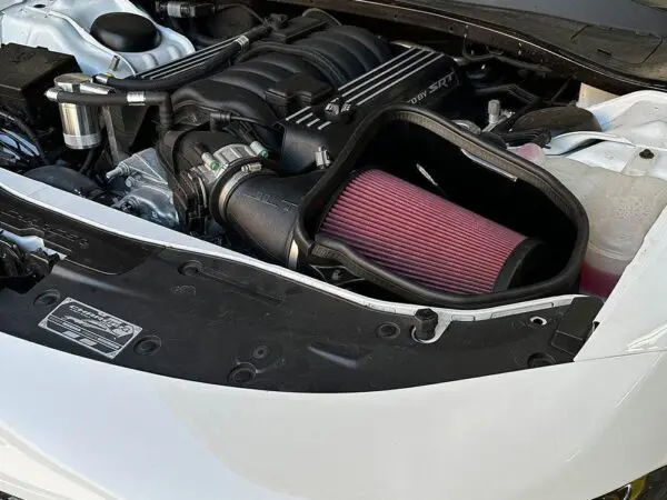 Car engine bay with visible air filter.