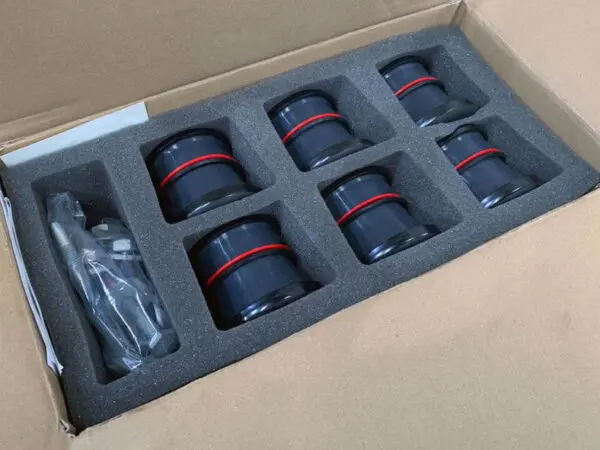 Box of black and red plastic connectors.