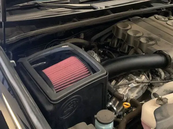 Car engine with visible air filter system.